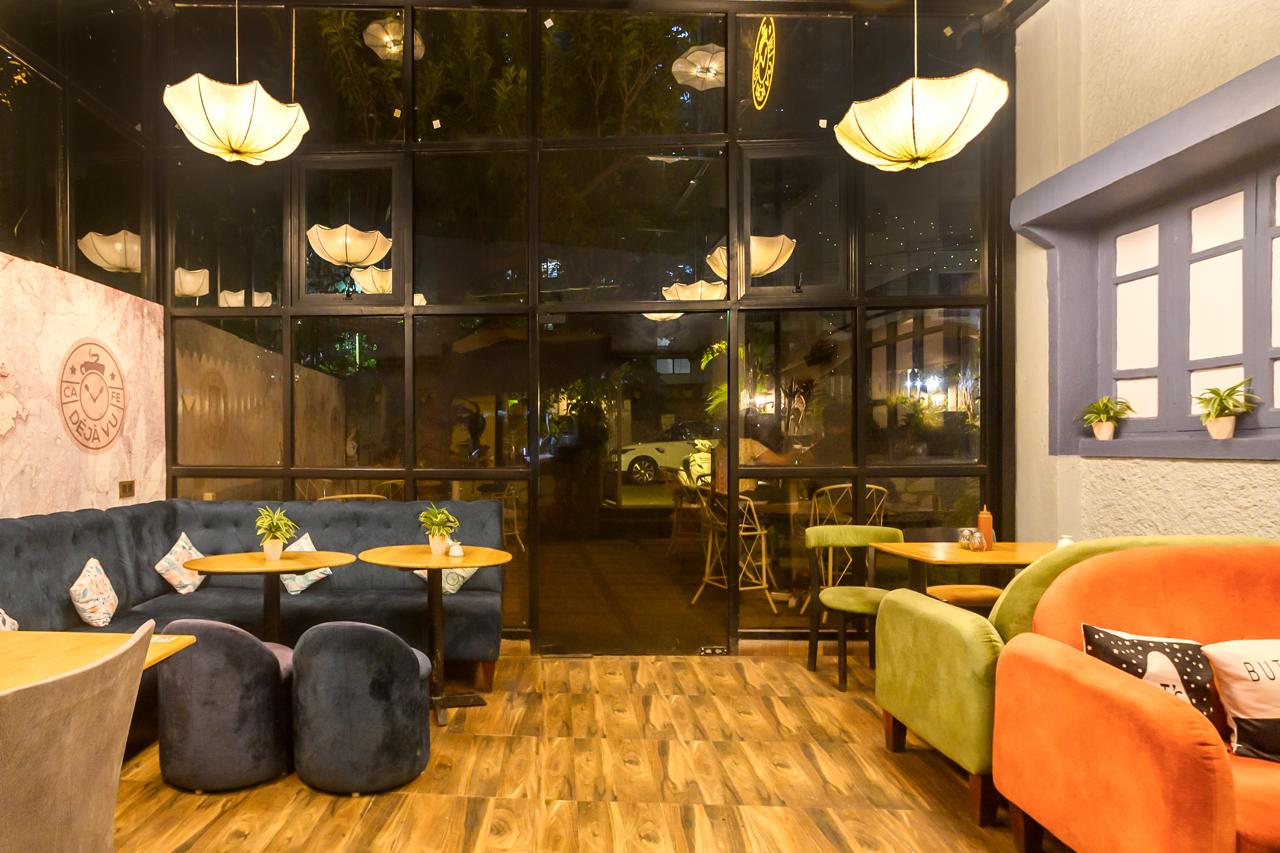 Cozy evening ambience inside the cafe looking out through the glass facade